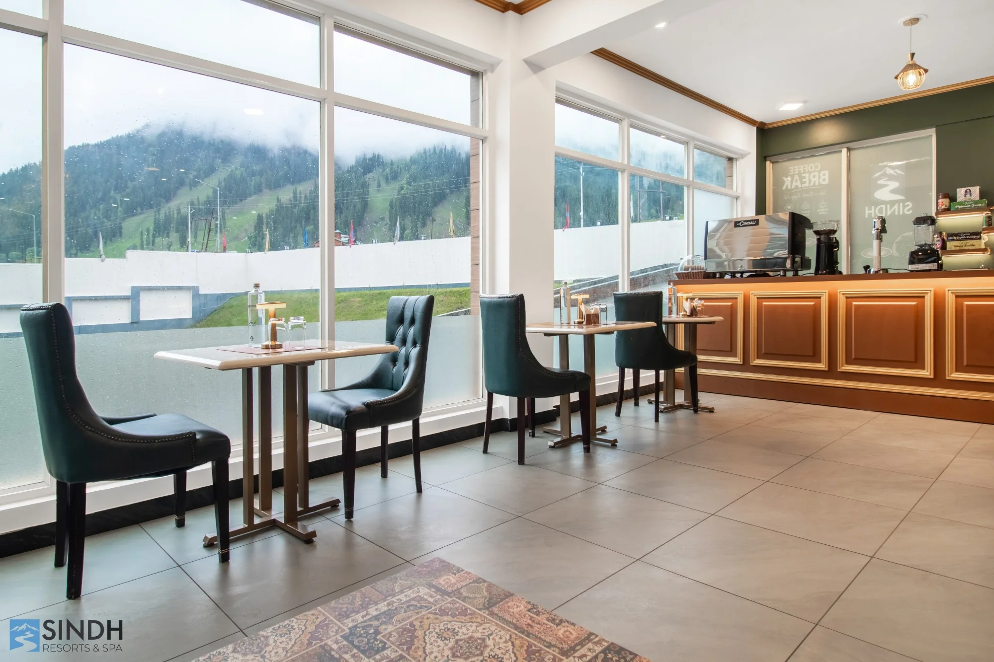 The Sindh cafe with window tables and misty mountain views