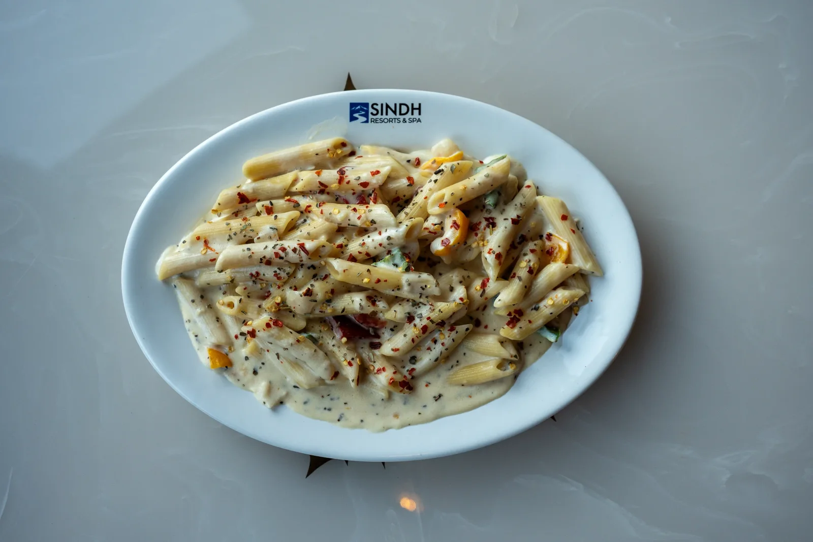 Creamy penne pasta with herbs and chilli flakes