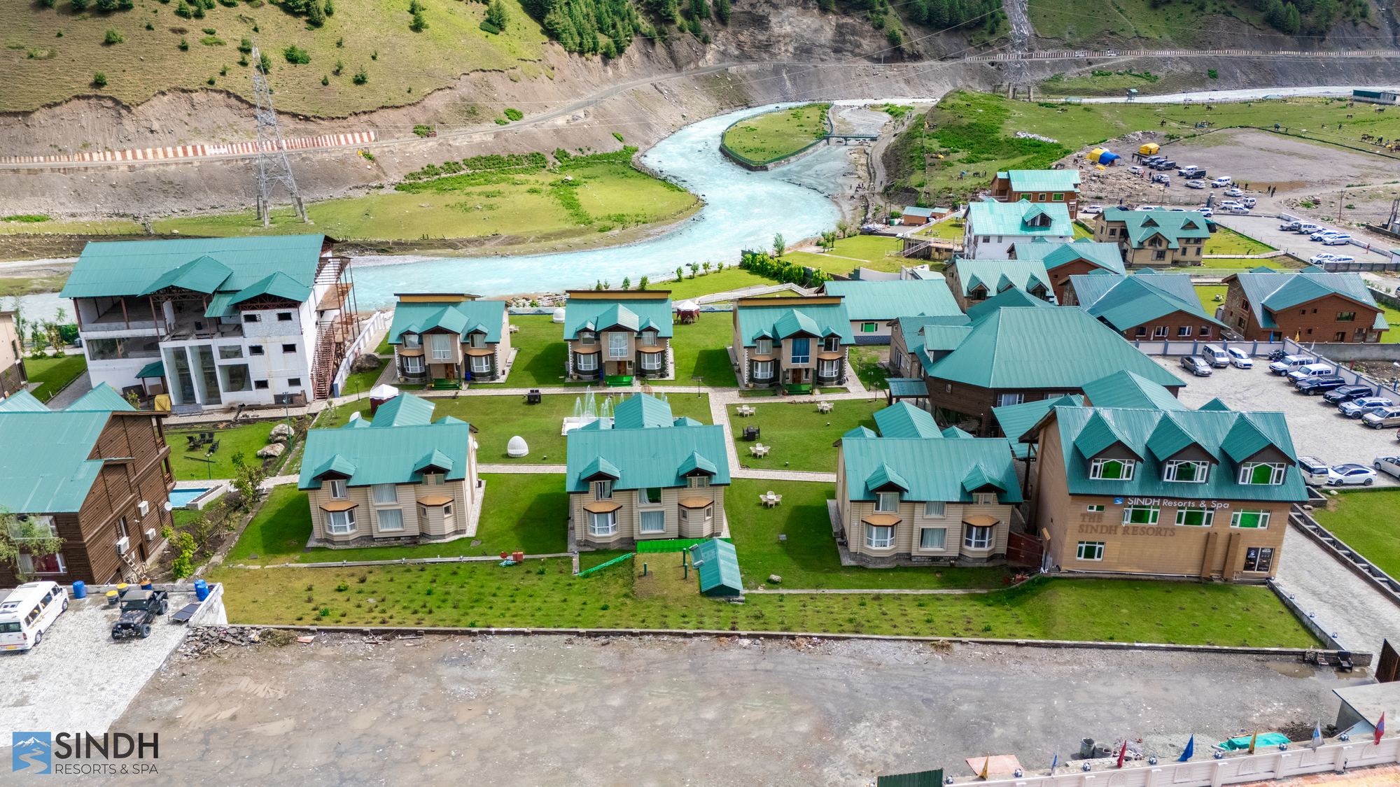 Cottages and lawns with the Sindh river behind